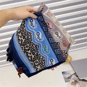 Detailed view of an ethnic style tassel shawl with mixed paisley patterns