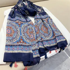 Close-up of navy blue ethnic paisley print shawl featuring decorative tassels and soft fabric