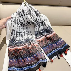 Detailed view of the ethnic paisley pattern and soft tassel trim on this stylish scarf.