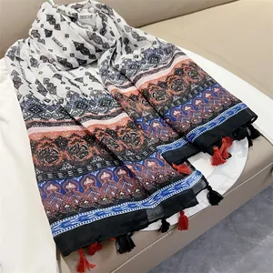Detailed view of ethnic style shawl featuring vintage paisley floral prints and tassels