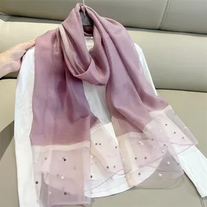 Detailed view of lavender faux silk scarf featuring delicate pearl embellishments