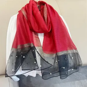 Elegant red and black gradient faux silk scarf with pearl embellishments and metallic gold trim