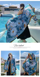 Ethnic style floral scarf shawl worn by model at a sunny outdoor resort pool