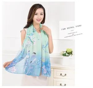 Detailed view of a lightweight chiffon long scarf with magpie and flower print