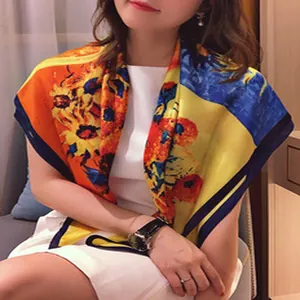 Detailed view of Van Gogh Sunflowers patterned faux silk scarf worn as a stylish shawl