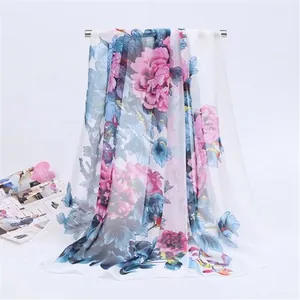 Detailed view of the elegant drape and floral bird print of this lightweight chiffon scarf