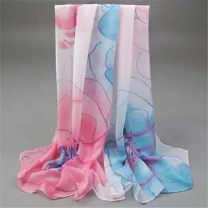 Macro view of a lightweight chiffon scarf featuring elegant pink and blue floral patterns.