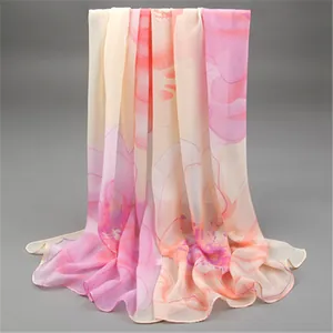 Detail view of an elegant long chiffon scarf featuring delicate pink and orange floral print