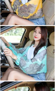 Detailed view of women's chiffon paisley sunscreen shawl used while driving