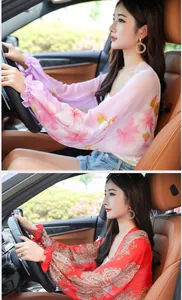 Woman wearing lightweight chiffon sun protection shawl for driving, floral and red patterns