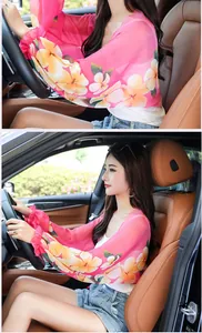 Detailed view of a pink floral chiffon sun protection shawl worn by a driver in a car