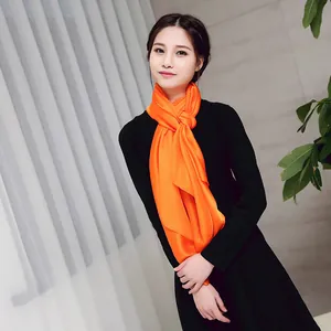 Elegant vibrant orange satin silk-like scarf shown as a long shawl on an Asian model