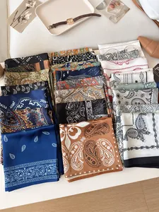 Detail view of various vintage silk scarves with paisley patterns and elegant colors