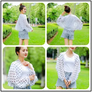 Detailed views of woman wearing a stylish white chiffon sun protection shawl with black polka dots
