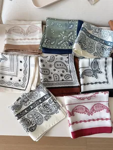 Macro view of various vintage paisley pattern small square silk scarves for women