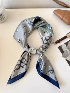 Close-up of a vintage paisley silk necktie scarf with grey and blue patterns