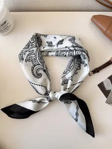 Elegant vintage paisley silk scarf for women shown with various lifestyle accessories.