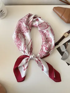 Detailed view of a vintage white and red paisley pattern silk scarf for women styling