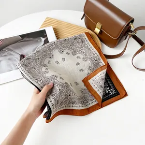 Detailed view of retro paisley pattern square scarf in brown and beige tones.