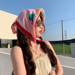Asian model wearing a 58cm floral cotton-linen headscarf in a sunny outdoor setting
