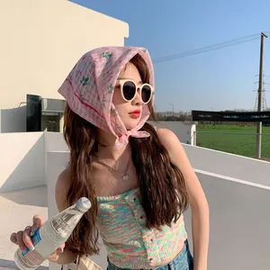 Detailed view of pink floral cotton linen headscarf worn as a stylish hair accessory