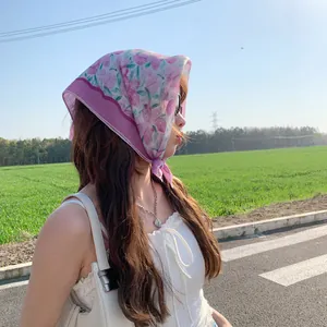 Floral cotton linen square scarf worn as a bohemian headscarf in natural sunlight