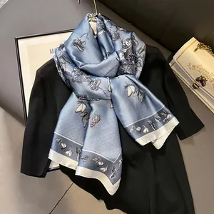 Eleganter blauer Seidenschal mit Schmetterlingsmotiven und geometrischen Mustern
