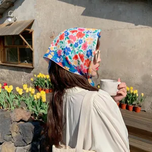 Floral cotton linen square scarf headscarf styled on model in an outdoor garden setting