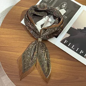 Elegant vintage pleated paisley print scarf with golden ring on a wooden table