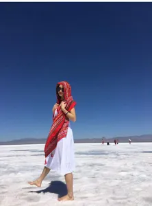 Vibrant red ethnic shawl shown in a scenic salt lake outdoor photography session