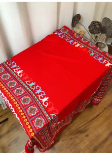 Large red ethnic shawl featuring vibrant tribal border patterns for travel and photography