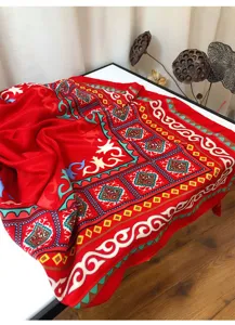 Detail shot of ethnic style red large scarf shawl for travel photography and sun protection