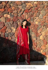 Detailed view of red ethnic shawl with intricate patterns for travel photography