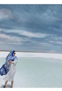 Elegant blue and white ethnic pattern shawl worn by a model in a scenic salt lake setting