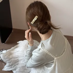Korean style green plaid rectangle hair clip accessory styled on a messy bun for women