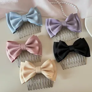 Detailed view of satin bow hair combs in five elegant pastel and classic colors.