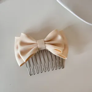 Elegant cream satin bow hair comb with silver metal insert teeth for hair styling