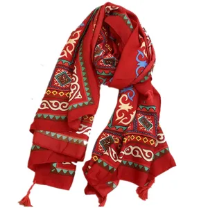 Large ethnic style red shawl scarf featuring vibrant tribal patterns and decorative tassels