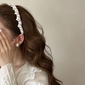 Close-up of a stylish grey plaid fabric headband worn by a woman for a Korean hairstyle
