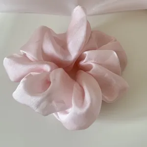 Detailed view of a delicate pink mesh scrunchie showing fabric texture