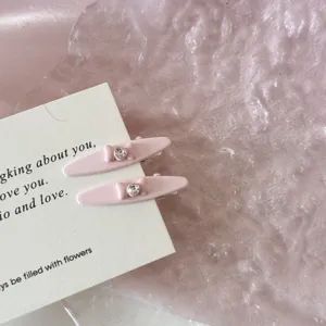 Close-up of elegant pink bowtie duckbill hair clips with rhinestones for girls