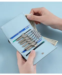 Detailed view of light blue leather key holder wallet with key hooks and card slots