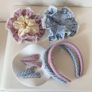 Collection of blue and purple plaid hair accessories including scrunchies, clips and headbands.