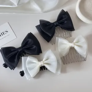 Close-up view of elegant black and white mesh bow hair combs and hair clips for girls