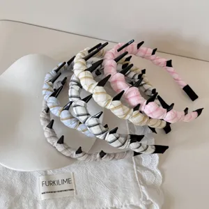 Collection of checkered cloth headbands with small black teeth in various colors
