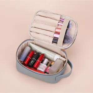 Detailed interior view of grey lychee leather cosmetic bag with brush slots and makeup storage
