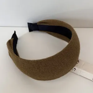 Macro shot of a thickened brown ribbed wide-brimmed headband for daily fashion wear