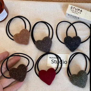 Variety of colorful plush heart hair ties with soft fuzzy texture for autumn