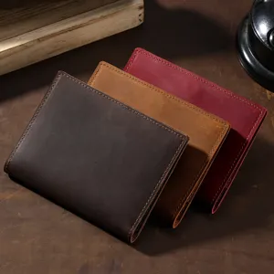 Handmade vintage crazy horse leather passport holders in three colors on rustic background