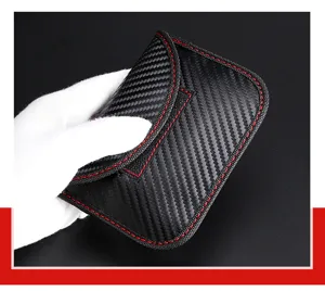 Macro detail of carbon fiber texture RFID signal blocking car key pouch with red stitching